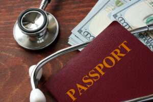 A passport and stethoscope on top of a table.