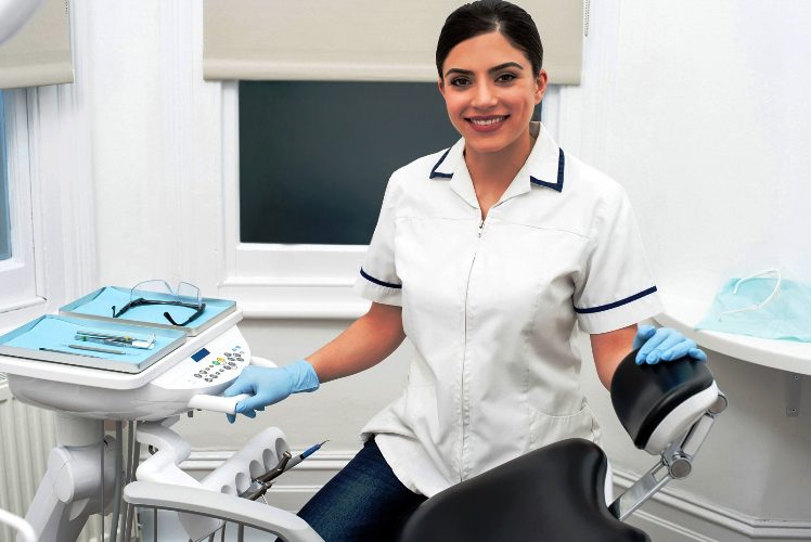 A woman in white shirt and blue gloves