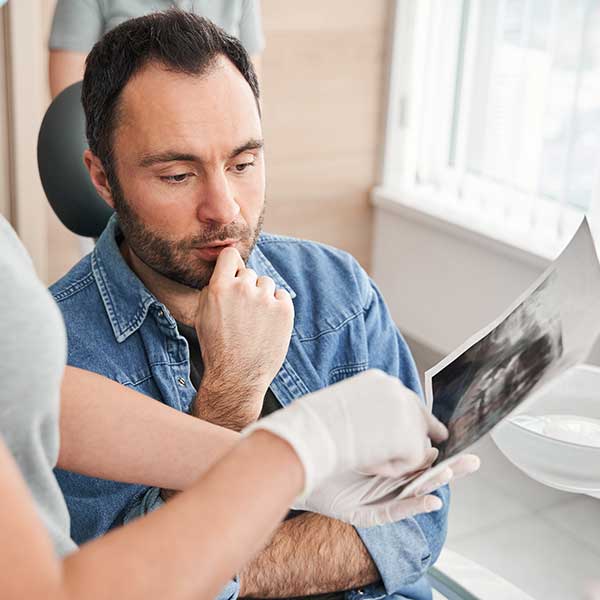 A male patient consulting a dentist.