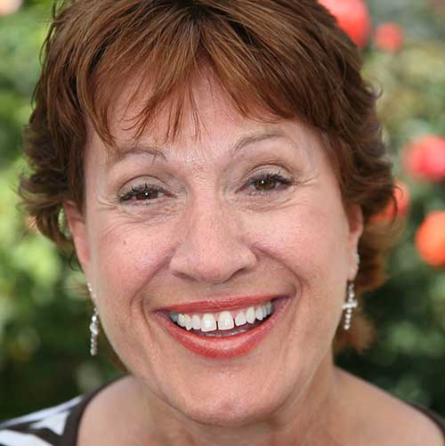 A happy woman smiling after implant procedure.