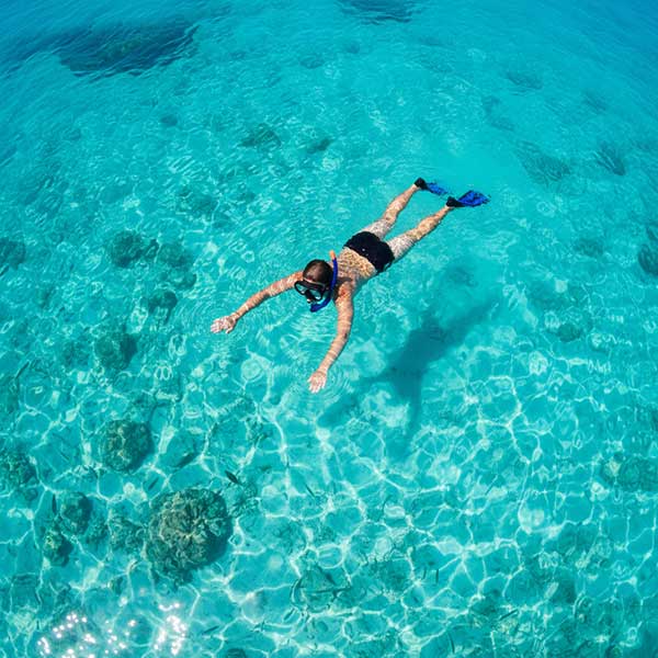 A young boy snorkeling in Playa del Carmen, Mexico.