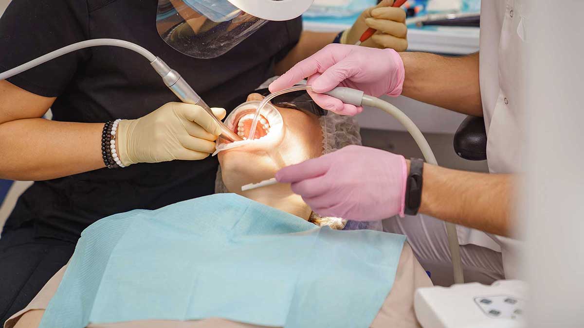 Dentist safely removing mercury amalgam on a patient.